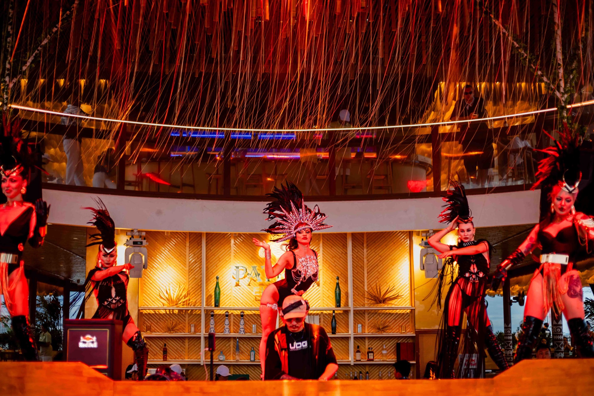 Sina by night — the upper bar aglow with performers under warm light